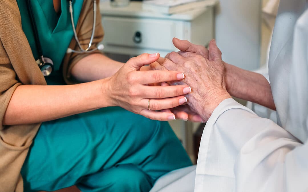 A clinician holding a patient's hands